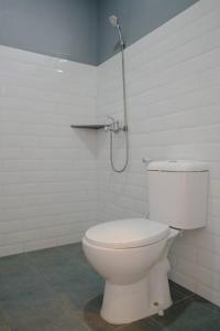 a white toilet in a bathroom with a shower at Puspiptek Residence Syariah in Curug 3