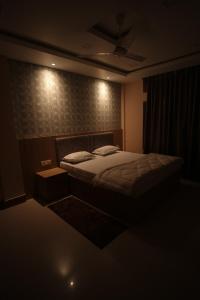 a bedroom with a bed in a dark room at Aroma Homes in North Lakhimpur