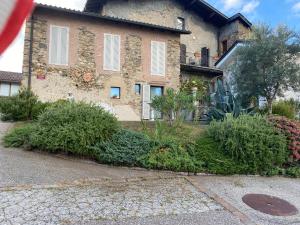 a large brick building with plants in front of it at Casa Emma in Monteggio +17 photos