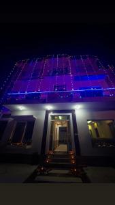 a building with purple lights on top of it at Soooper Hotel 2 in Jāmb +2 photos