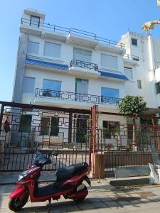 a scooter parked in front of a building at Soooper Hotel 2 in Jāmb