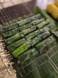 a grill with green vegetables and corn on it at Sol Flow Retreat in Nguyên Ngoại +20 photos