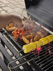 a bunch of meat and vegetables cooking on a grill at Sol Flow Retreat in Nguyên Ngoại