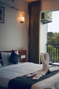 Ένα ή περισσότερα κρεβάτια σε δωμάτιο στο Nirvanica Retreat Wayanad