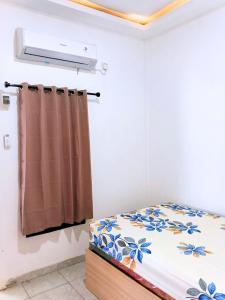 Ένα ή περισσότερα κρεβάτια σε δωμάτιο στο Casa Bella Homestay