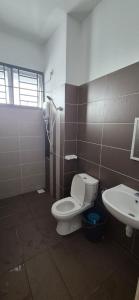 a bathroom with a toilet and a sink at Wonder Villa in Bandar Penawar +9 photos