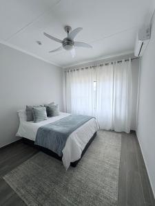 a bedroom with a bed with a ceiling fan at Haven & Beyond in Gaborone
