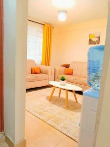 a living room with a couch and a table at Cosy Homes Eldoret in Eldoret