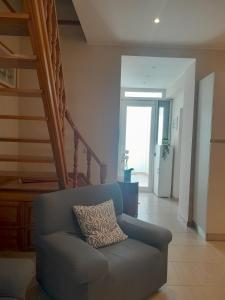 a living room with a couch and a staircase at Casa ERMES 151 in Floridia