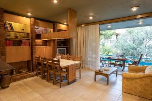 a kitchen and living room with a table and chairs at Retro House in Rafina