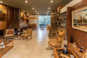 a living room with chairs and a brick wall at Retro House in Rafina