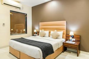 a bedroom with a large bed and a window at The Avenue Hotel & Banquet Near Bhopal Junction in Bhopal +17 photos