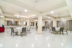 a large banquet hall with tables and chairs at The Avenue Hotel & Banquet Near Bhopal Junction in Bhopal