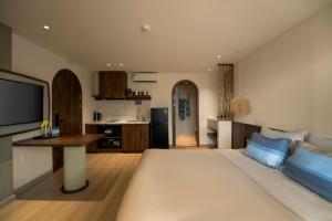 a living room with a large bed and a kitchen at Lune Boutique Apartment Da Nang in Da Nang +21 photos
