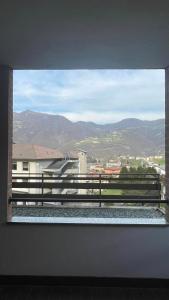 a window with a view of a building and mountains at Appartamento Torre 