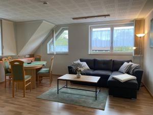 a living room with a couch and a table at Ferienwohnung Schreiter in Arnsfeld