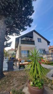 a house with a potted plant in front of it at Holiday home in Fonyod - Balaton 18627 in Fonyód