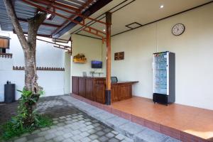 an empty room with a clock on the wall at Pondok Tegal Tunon Villa Ubud Bali in Ubud