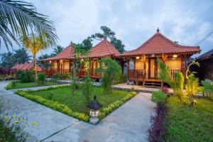 a house with a garden in front of it at Pondok Tegal Tunon Villa Ubud Bali in Ubud