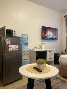 a small kitchen with a table and a refrigerator at Habun Homes in Ruaka