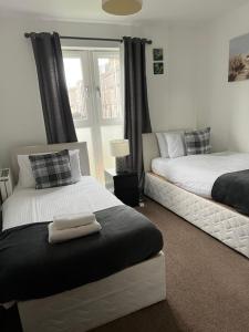 Ένα ή περισσότερα κρεβάτια σε δωμάτιο στο Caledonian Apartment