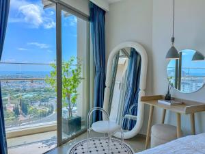 a bedroom with a bed and a large window at The Song Apartment 5 Stars Vung Tau - Căn Hộ Du Lịch 5 Sao Cạnh Biển - DUMIN HOMESTAY in Vung Tau +158 photos