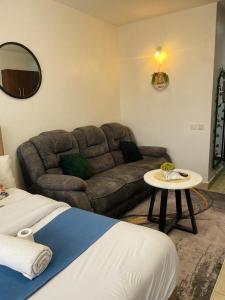 a living room with a couch and a table at Habun Homes in Ruaka