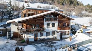 an aerial view of a house in the snow at NATURLODGE Ladis - Nature Lodges with Mountain Views in Ladis