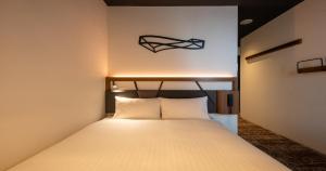 Una cama o camas en una habitación de QuintessaHotel Osakaumeda Comic&Books 5 fotos más