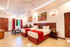 a bedroom with two beds in a room at PrideInn Hotel Nyali in Mombasa +33 photos