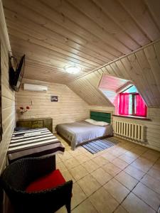 a bedroom with a bed and a window in a room at Hotel Bannyi Dvir in Uzyn