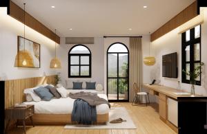 a bedroom with a bed and a desk and windows at The Motifs Eco Hotel - SHA Extra Plus in Chanthaburi