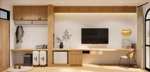 a living room with a desk and a tv at The Motifs Eco Hotel - SHA Extra Plus in Chanthaburi