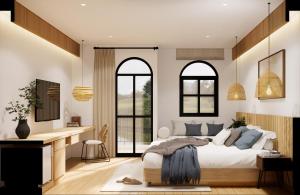 a bedroom with a bed and a desk and two windows at The Motifs Eco Hotel - SHA Extra Plus in Chanthaburi +71 photos