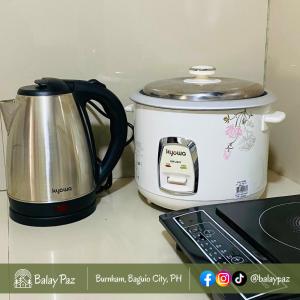 a slow cooker and a toaster sitting on a counter at Spacious 2BR Family Home - Narra Unit by Balay Paz in Baguio
