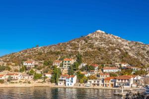 a town on a hill next to the water at Apartments in Starigrad kod Senja 27140 in Starigrad