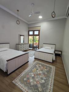 a bedroom with two beds and a rug at استراحة غوانا 