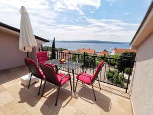a table and chairs on a balcony with a view at Apartment in Crikvenica 34973 in Sopaljska