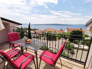 a table and chairs on a balcony with a view at Apartment in Crikvenica 34973 in Sopaljska