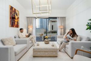 a group of people sitting in a living room at Westminster ACT1 ACT2 in Dubai