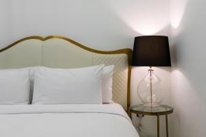 a bedroom with a bed with a lamp on a table at Westminster ACT1 ACT2 in Dubai +71 photos