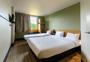 Ένα ή περισσότερα κρεβάτια σε δωμάτιο στο B&B HOTEL Marne-la-Vallée Bussy-Saint-Georges +25 φωτογραφίες