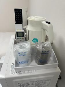 a white appliance with a blender on top of a refrigerator at 未来ホテル MiraiHotel in Isesaki +8 photos