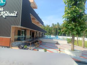 a building with a tree in front of it at Oceanus Retreat in Mayyanād