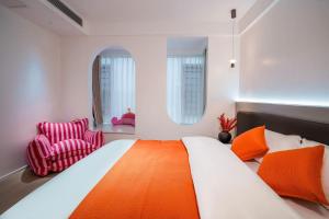 a bedroom with a large bed and a chair at 4 RMs city APT, Easy to go all attractions in Zhangjiajie