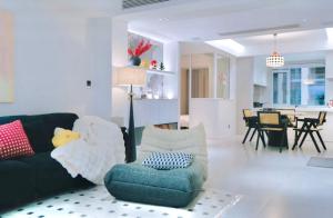 a living room with a couch and a dining room at 4 RMs city APT, Easy to go all attractions in Zhangjiajie