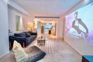 a living room with a large screen in a house at 4 RMs city APT, Easy to go all attractions in Zhangjiajie