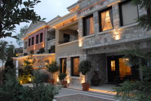a large house with lights on the side of it at Leventis Art Suites in Panayítsa