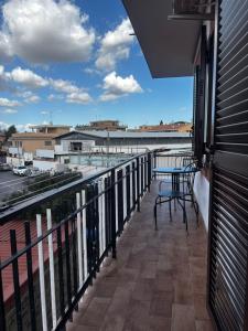 a balcony with a table and a view of a street at Roxy's Home in Rome in Rome
