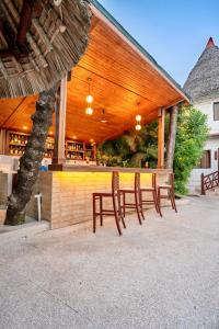 a group of tables and chairs in front of a building at PrideInn Hotel Nyali in Mombasa